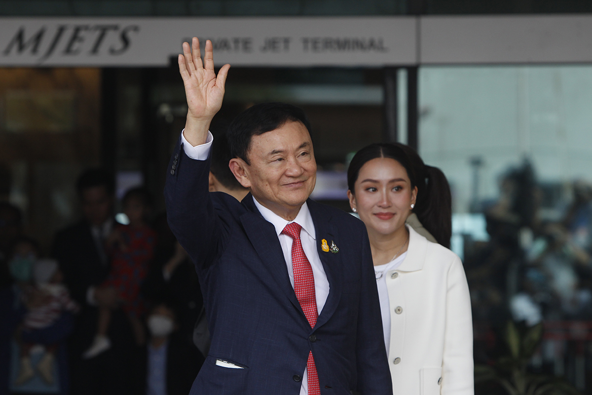 Former Thai Prime Minister Thaksin Shinawatra waves to his supporters after his return to Thailand at the private jet terminal at Don Mueang airport in Bangkok August 22, 2023. Photo: Chaiwat Subprasom, Shutterstock